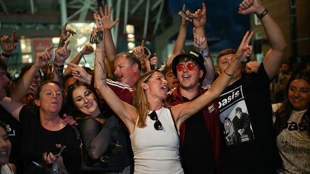 Jovial Oasis fans waiting to enter a concert